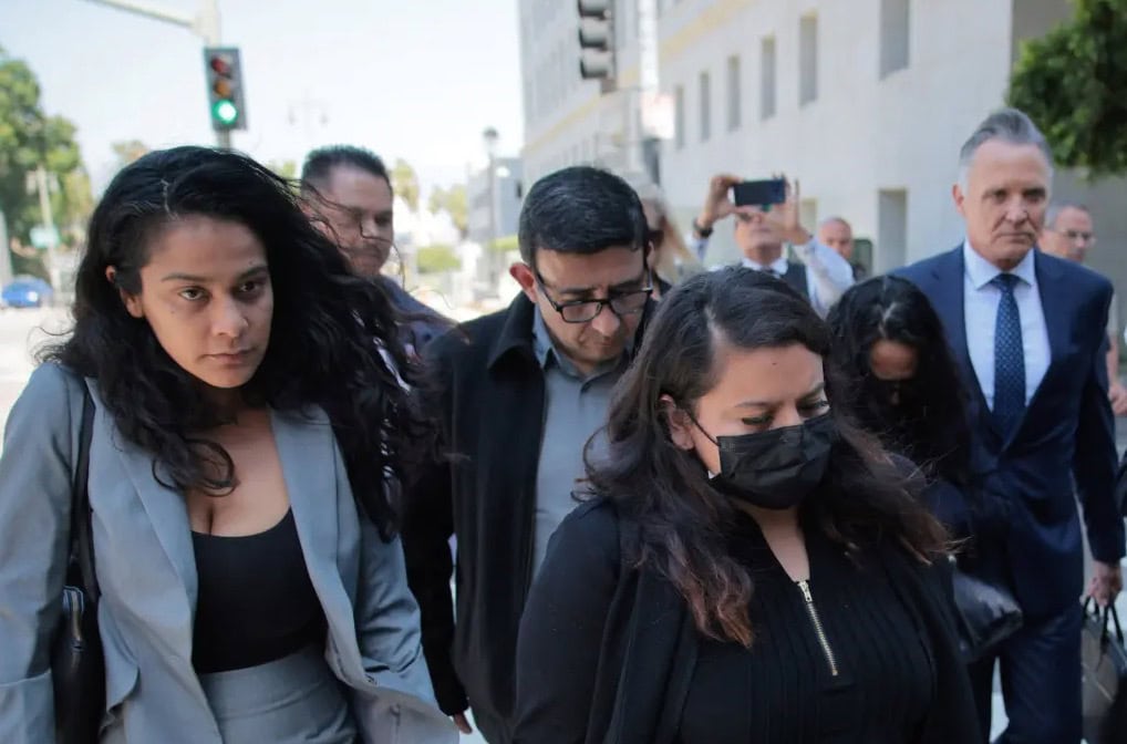 Patrick Steinfeld and his clients walking into court while being followed by press and media.
