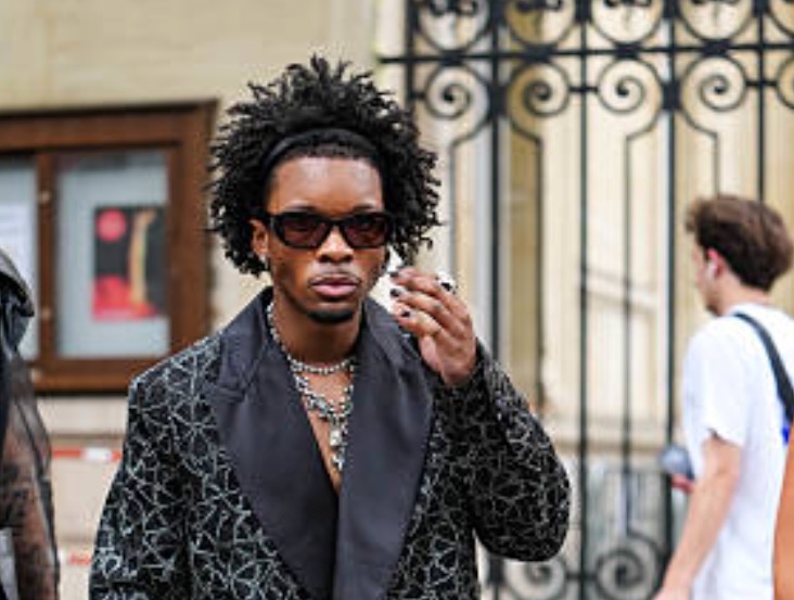 D4vd in a custom suit, walking down a street