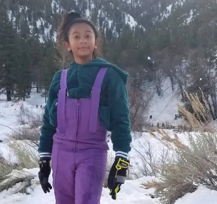 A young Celeste Rivas Hernandez playing in the snow