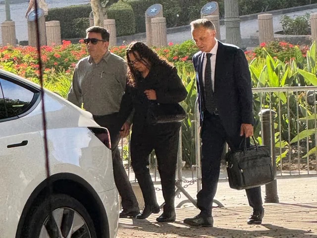 Attorney Patrick Steinfeld helps Celeste's mother to her car.